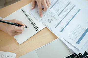 Woman is checking credit card bill information at living room inside house 