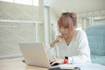 woman using laptop at at living room inside house.