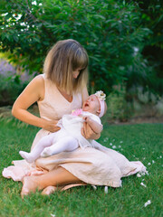 Mother with her crying baby in outdoor garden