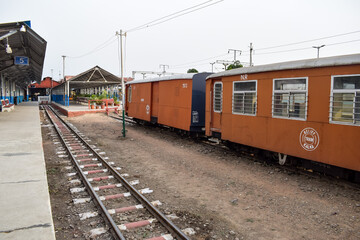 Fototapeta premium View of Toy train Railway Tracks from the middle during daytime near Kalka railway station in India, Toy train track view, Indian Railway junction, Heavy industry
