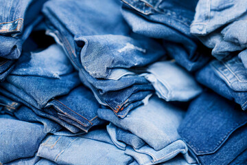 A stack of blue jeans with one of them missing the bottom Generative ai
