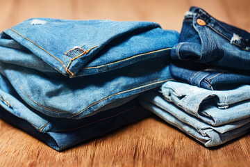A stack of blue jeans with one of them missing the bottom Generative ai