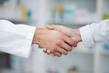 Doctor, handshake and partnership in support at pharmacy for healthcare success, promotion or deal...