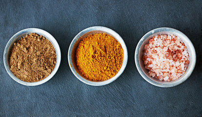 Bowls of flavor. an assortment of colorful spices in bowls.