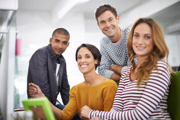 Teamwork with a smile. Cropped view of a group of young designers working together.