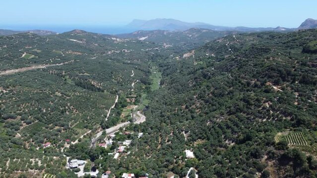 Aerial View Of Mountain Village Of Topolia In Crete, Greece Surrounded By Natural Greenery.