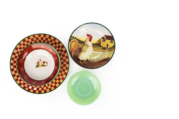 Chicken ceramic plates and small green plate next to it. isolated on white background