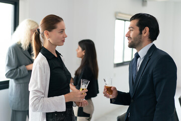 Corporate co-workers having drinks after meeting, People clinking glasses with sparkling wine indoors, Business people celebrating inside modern office.