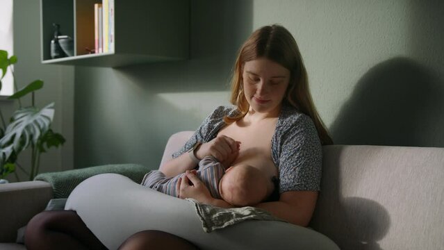 A Mother Breastfeeding A Newborn Baby