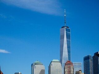 Looking back on Manhattan from the Hudson River and Liberty Island, as the towering high rises of...