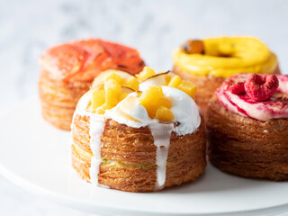 Assorted croissant donuts on a marble background