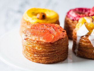 Assorted croissant donuts on a marble background