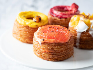 Assorted croissant donuts on a marble background