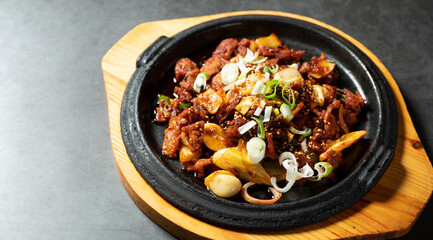 Spicy stir-fried meat on iron plate