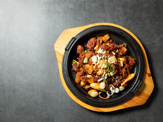 Spicy stir-fried meat on iron plate