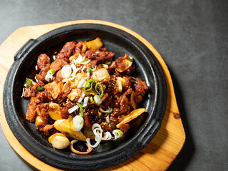 Spicy stir-fried meat on iron plate