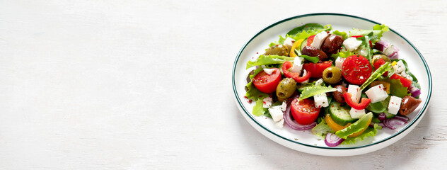 Greek village salad horiatiki with feta cheese, olives, cherry tomato, cucumber and red onion,...