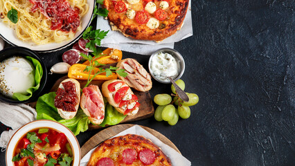 Italian food dishes on dark background.