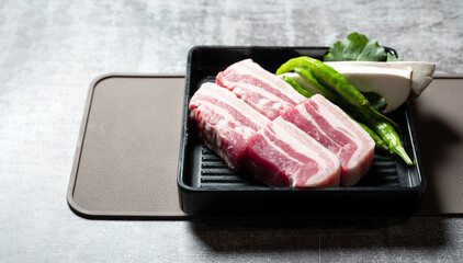 Samgyeopsal, mushrooms and vegetables on a plate