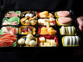 A variety of cheeses, raw hams and sweets	
