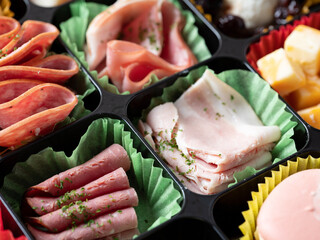 A variety of cheeses, raw hams and sweets	