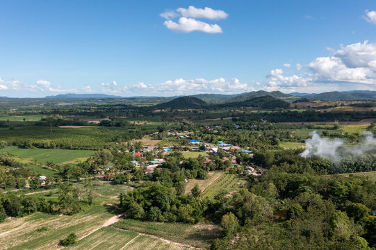 The aerial picture of Hui Kha Khaeng atmosphere, green forest and mountains, in Tak province, Thailand. The enormous wildlife sanctuary environment with sunlight and clouds on the blue sky.