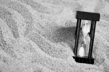 hourglass on the sea sand beach. passing time in a countdown sandglass with copy space for add text...