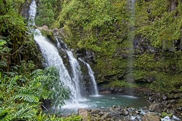 The Road to Hana is a narrow winding highway on the Hawaiian island of Maui with numerous waterfalls and other scenic sights