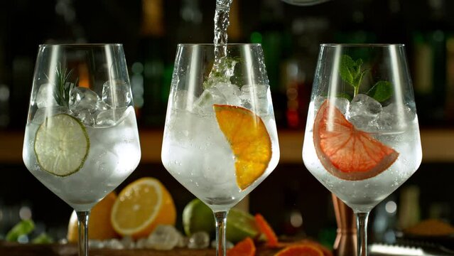 Super Slow Motion Shot of Pouring Gin and Tonic Into Long Glasses with Camera Motion at 1000fps.