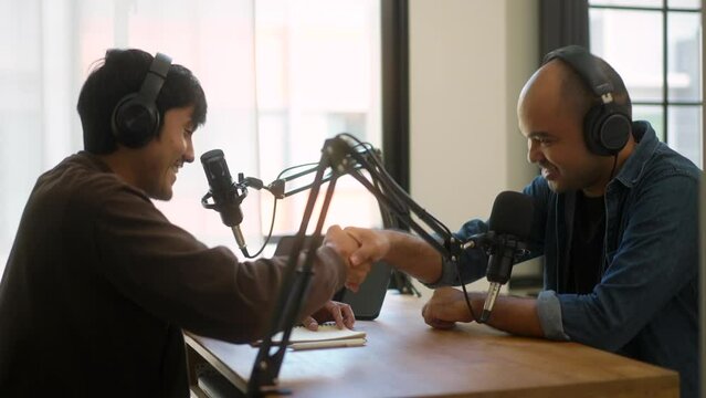 Podcast recording content creator. Two man hosting creator streaming in online and radio with headphones and condenser microphone interview cheering conversation motivation at home broadcast studio