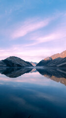 Fototapeta na wymiar sunrise of lake and mountains in new zealand as vertical wallpaper