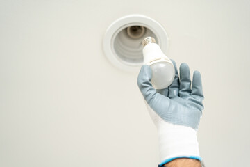 Electrician installing led light bulbs at home for power saving. Fixing changing the Light Inside...