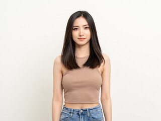 Beautiful smiling happy young asian woman age around 25 in brown shirt. Charming female lady standing pose on isolated white background. Asian cute people looking camera confident with white backdrop.