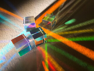 Artistic dispersion of artificial light, dichroic square glass cube spreading narrow beam of light...