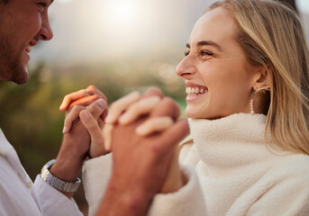 Love, couple and holding hands outdoor with a smile, care and romance on date in nature. Young man...