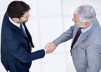 Making deals happen. High angle shot of a two businessmen shaking hands.