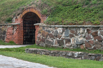 Arched door in vintage white brick wall
