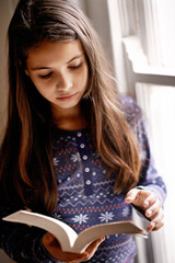 Today a reader tomorrow a leader. Portrait of a cute little girl reading at home.