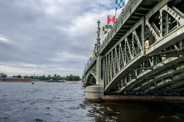 Trinity Bridge across the Neva River in St. Petersburg, decorated with signal flags, on the Day of the Russian Navy