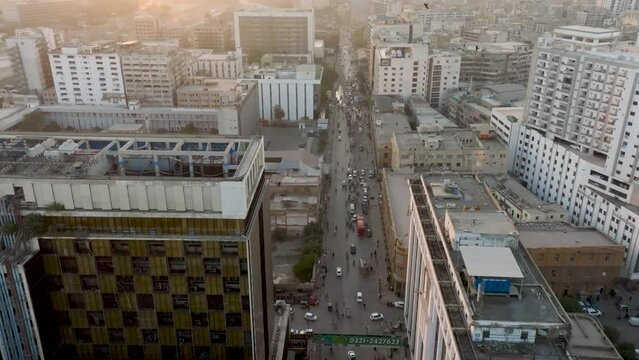 Aerial Flying Over Modern Office Building In Karachi During Sunset Light With Birds Flying Around. Dolly Forward 