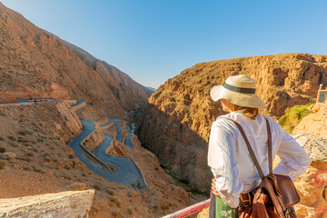 Young tourist looking at the dades gorge road. is a gorge of the Dades River in the Atlas Mountains of Morocco. The depth of the Dades gorge is from 200 to 500 meters. © xamnex