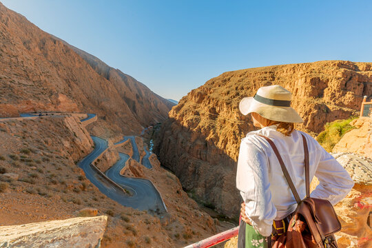 Young tourist looking at the dades gorge road. is a gorge of the Dades River in the Atlas Mountains of Morocco. The depth of the Dades gorge is from 200 to 500 meters.