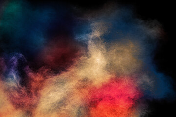 Explosion of colorful Holi powder on black background. Vibrant color dust particles textured...