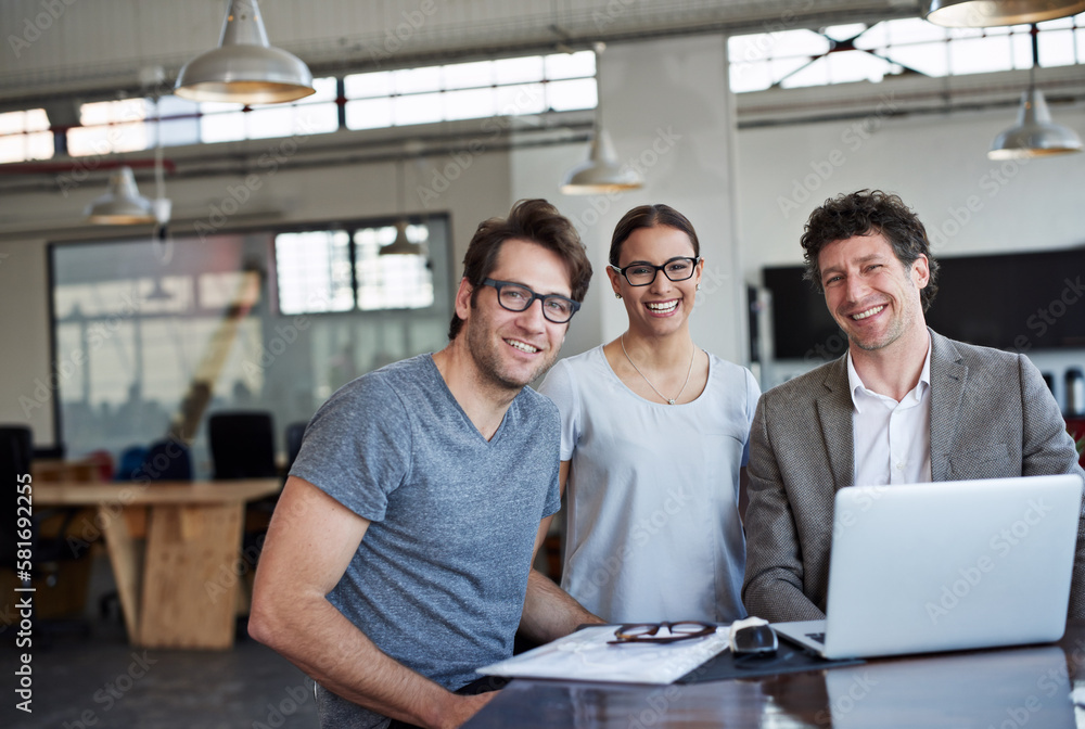 Poster getting the job done with smiles on their face. portrait of three business colleagues in the office.