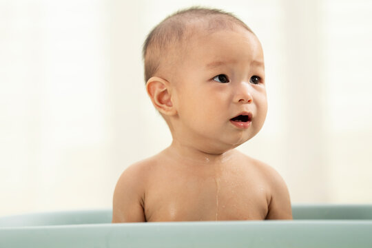 Lovely baby sat on the tub bath