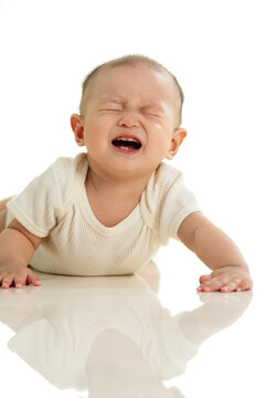 The lovely baby prone on the floor crying