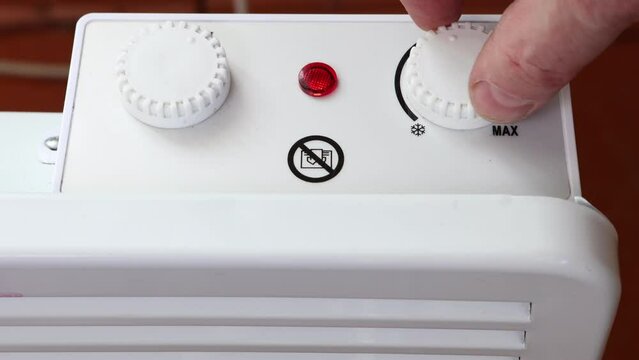 To save energy, thermostat of convector heater is turned to minimum position.