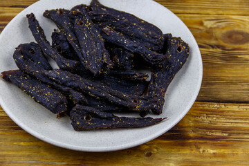 Slices of biltong (South African dried meat) on wooden table