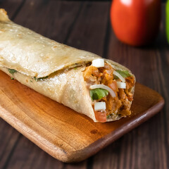 Peri Peri Wrap paratha roll served in wooden board side view of indian fastfood