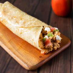 Crispy Chicken Wrap paratha roll served in wooden board side view of indian fastfood